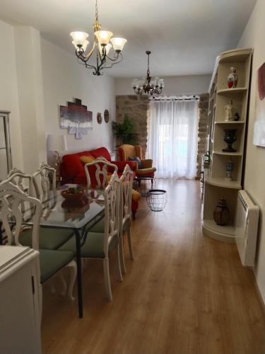 a living room with a table and a couch at Vivienda Turística LA TRINIDAD in Úbeda
