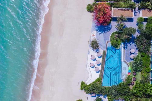 an overhead view of a beach with a pool and the ocean at Baba Beach Club Hua Hin Luxury Pool Villa by Sri panwa in Cha Am