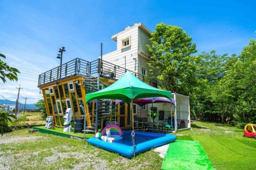 a house with a playground in front of it at 宜蘭81 Boat輕旅 寵物友善 小團體包棟 獨棟villa in Jiaoxi