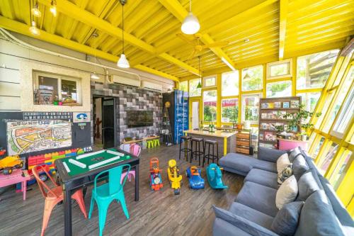 a living room with a couch and ping pong table at 宜蘭81 Boat輕旅 寵物友善 小團體包棟 獨棟villa in Jiaoxi