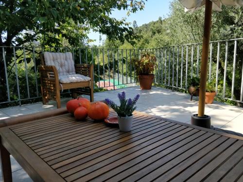 a table with pumpkins and a chair on a patio at Quinta de São Simão Turismo e Eventos in Vieira do Minho