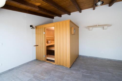 a wooden cabinet in the corner of a room at Luxury Villa Nature with heated private pool, sauna & fire pit, a short walk to the beach in Milna