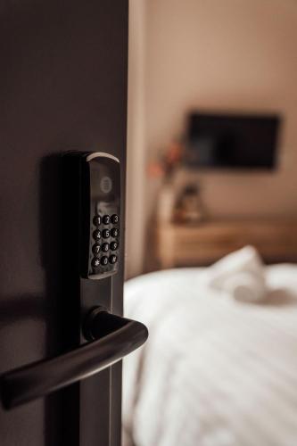 a hotel room with a bed and a remote control at Hotel bij Jacob in Enschede