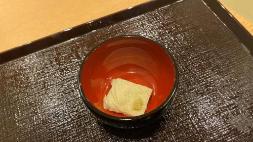 a black bowl with food in it on a table at Onyado Nono Asakusa Natural Hot Spring in Tokyo