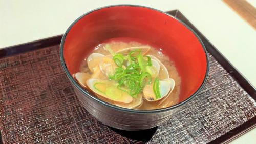 a red bowl of soup on a tray at Onyado Nono Asakusa Natural Hot Spring in Tokyo