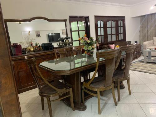 a dining room table with chairs and a mirror at Comfort & Relax at Maadi in Cairo