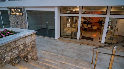 a store front with stairs and glass windows at Plaza Hotel in Masouri