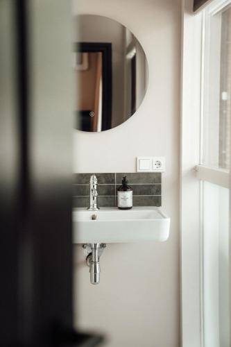 a bathroom with a sink and a mirror at Hotel bij Jacob in Enschede