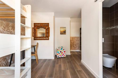 a room with white walls and a wooden floor at Appartement Maeva in Saint-Pée-sur-Nivelle