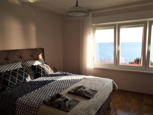 a bedroom with a bed with two towels on it at Apartment Zeljka in Crveni Vrh