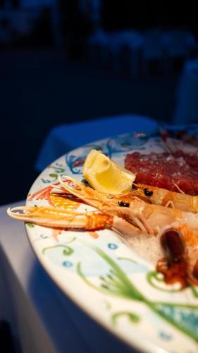a plate of food with food on a table at Casa Mita in Pulsano