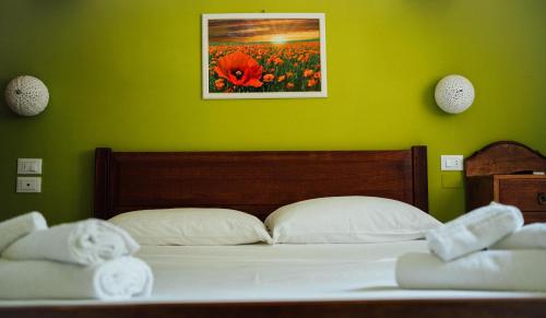 a bedroom with a bed with a green wall at Casa Mita in Pulsano