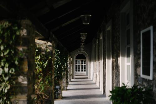 a hallway of a building with a white door at Mount Juliet Estate, Autograph Collection in Thomastown