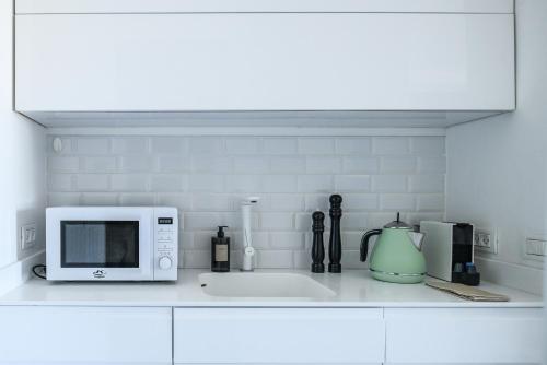 a kitchen counter with a microwave and a sink at HaTsuk Beach Sea-View Studio by Sea N' Rent in Jlil