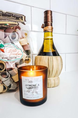 a bottle of wine and a candle in a refrigerator at Principality View Apartment One, by Solace Stays in Cardiff