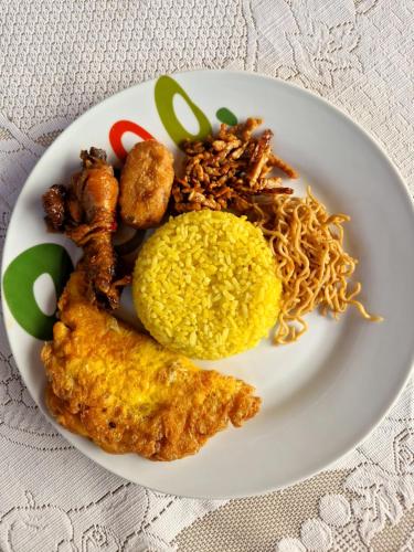 a plate of food with rice and other foods at The Sanduk Homestay in Rantepao