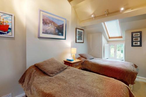 a bedroom with two beds and a window at Pen Y Bryn in Llanrwst
