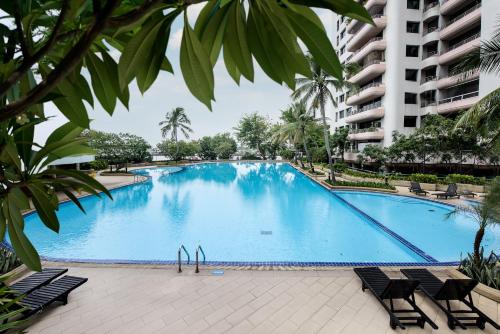 a large swimming pool in the middle of a building at Riverine Place Hotel and Residence in Nonthaburi