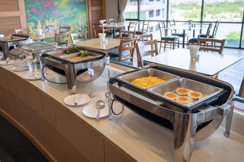 a buffet line in a restaurant with breakfast foods at Riverine Place Hotel and Residence in Nonthaburi