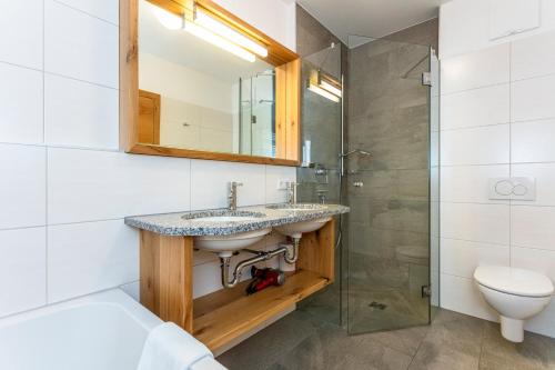 a bathroom with a sink and a shower at Appartements Ferienwohnungen Unser Unterberg in Maria Alm am Steinernen Meer