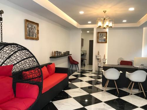 a living room with a red couch and chairs at The CHESS Samui in Chaweng
