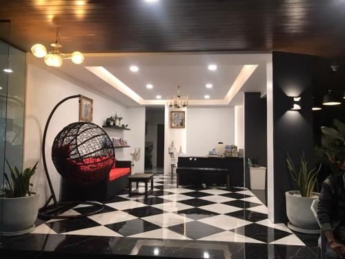 a living room with a black and white checkered floor at The CHESS Samui in Chaweng