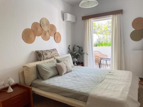 a bedroom with a large bed and a window at My Porto Villa in Porto Rafti