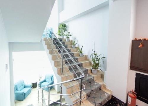 a spiral staircase with potted plants on it at Hotel Duet in Piteşti