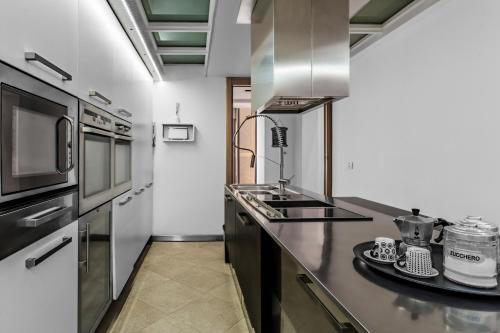 a kitchen with stainless steel appliances and a counter top at La bella vita luxury apartament and travel solution in Naples