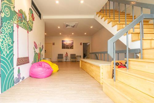 a room with a bunk bed and stairs at Paknap Hostel in Nan