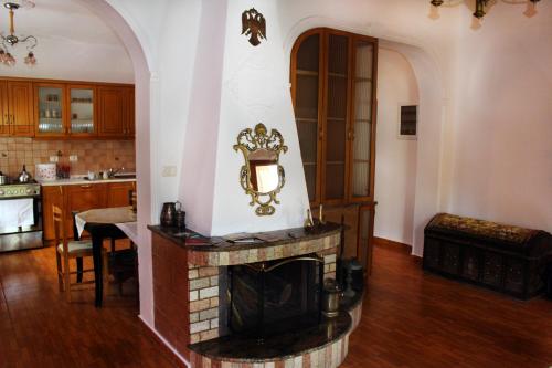 a living room with a fireplace in a kitchen at Margarita - Entire house with 4 bedrooms and free parking in Gjirokastër