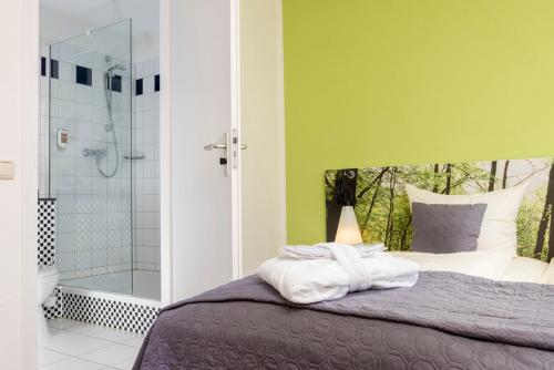 a bedroom with a bed and a shower at Eurostrand Resort Moseltal in Leiwen