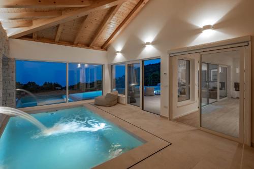 a swimming pool in a villa with a view at Luxury Villa Dana Indoor Pool and Sauna - Happy Rentals in Ičići