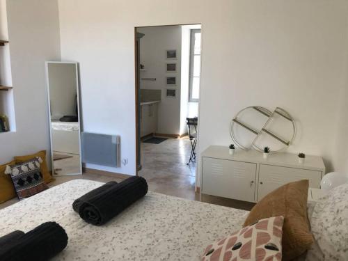 ein Wohnzimmer mit einem Sofa und einem Spiegel in der Unterkunft La Maison Racine 4 - Cocon en plein centre ville in Avignon