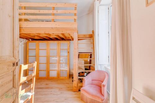 a room with a loft bed and a chair at Charmant et lumineux T2 centre ville au calme in Nantes