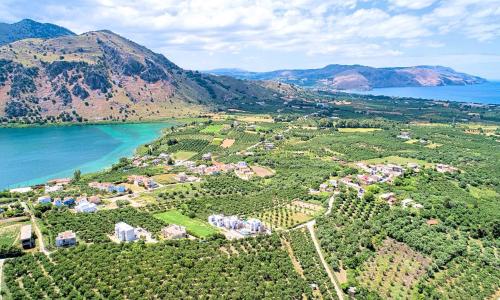 an aerial view of a village next to a lake at Vista Mare Villas Heated Pool in Georgioupoli