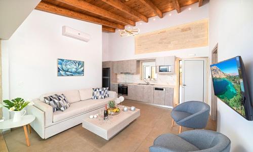 a living room with a couch and chairs and a table at Vista Mare Villas Heated Pool in Georgioupoli
