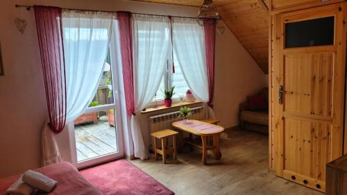 a small room with a table and a window at Agroturystyka Kasprzykówka 