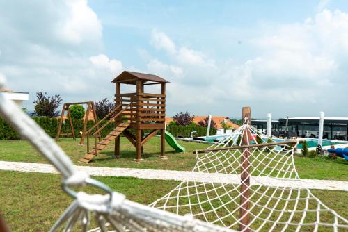 a playground with a slide and a swing set at Alexander Resort in Sopot
