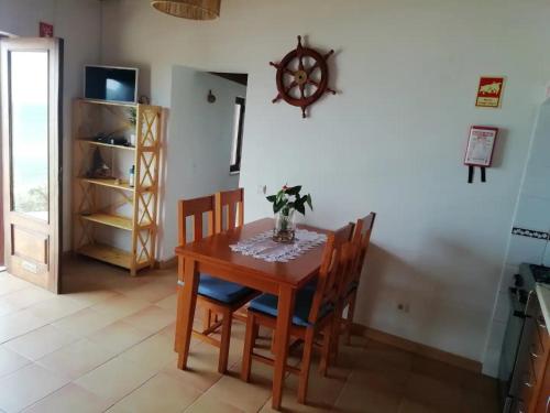 a dining room with a wooden table and chairs at Bela Vista in Aljezur