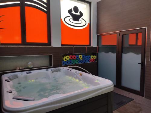 a large bath tub in a bathroom with orange at Hostel S. Miguel FitNCare in Guarda