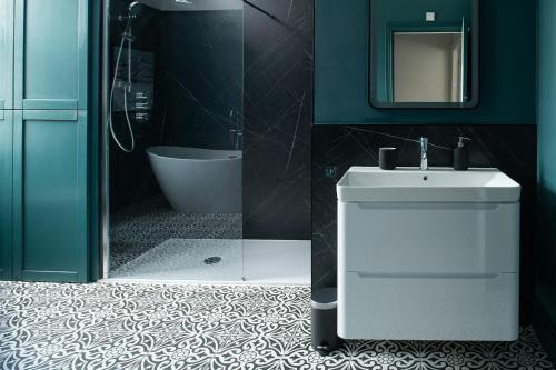 a bathroom with a toilet and a sink and a mirror at Nythfa in Llanrwst