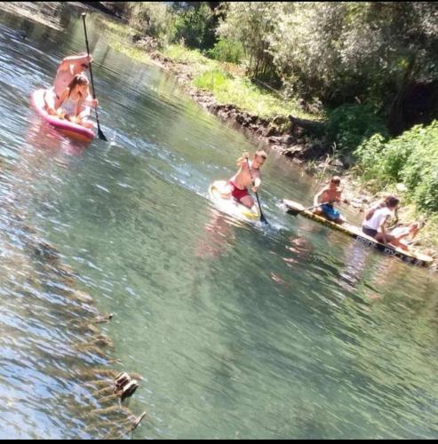 a group of people riding on rafts in a river at House Markovic in Gornja Plavnica
