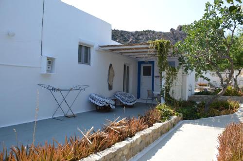 a patio with two benches in front of a white building at Summer Residence in Provatas