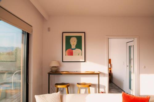 a living room with a couch and a table with chairs at eftopia in Balodhimaíika