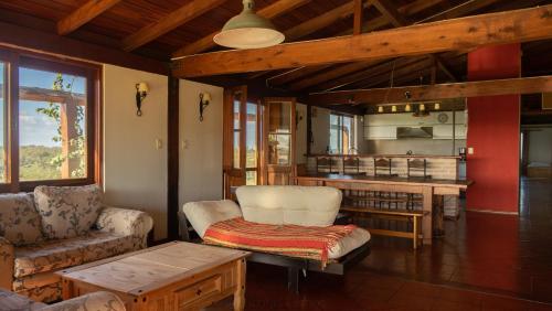 a living room with a couch and a table at Hostería La Bordona in Rivera