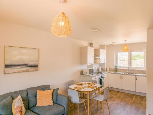a living room with a couch and a table at 4 Ben Avon in Aviemore