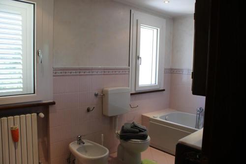 a bathroom with a toilet and a sink and a tub at Relax and apartment in SantʼAgata Feltria