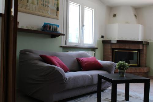 a living room with a couch and a fireplace at Relax and apartment in SantʼAgata Feltria