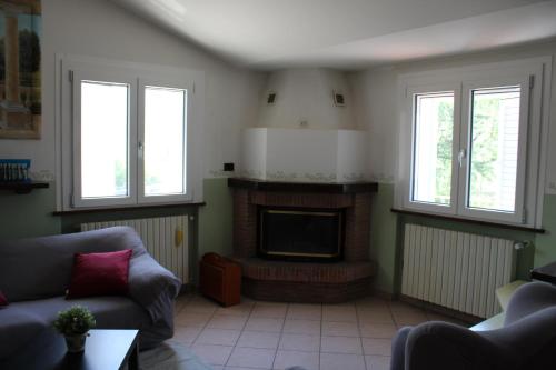 a living room with a couch and a fireplace at Relax and apartment in SantʼAgata Feltria